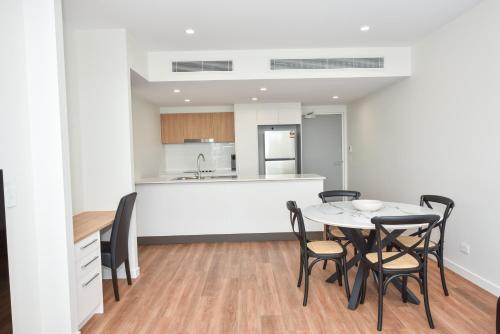 a kitchen and dining room with a table and chairs at Brisbane International Virginia in Brisbane