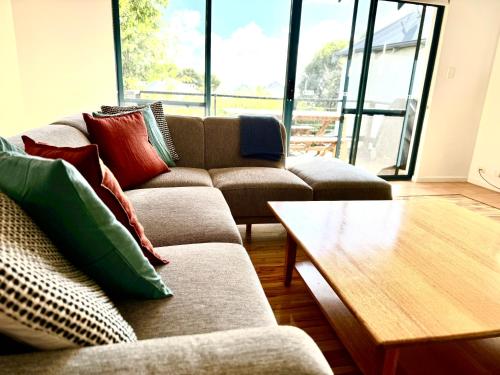 a living room with a couch and a coffee table at Margaret River Beach Houses in Gnarabup