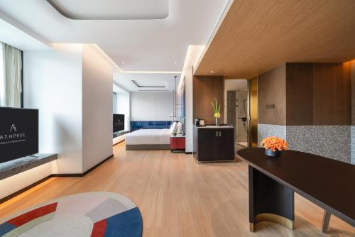 a large living room with a bed and a table at A T HOUSE Shanghai City Center Xujiahui - Free Night Snacks from 930pm-11pm in Shanghai