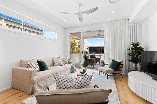 a living room with a couch and a tv at Haven On Hooper in Gold Coast
