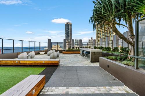 a patio with benches and a view of the city at Rhapsody Resort - Official in Gold Coast