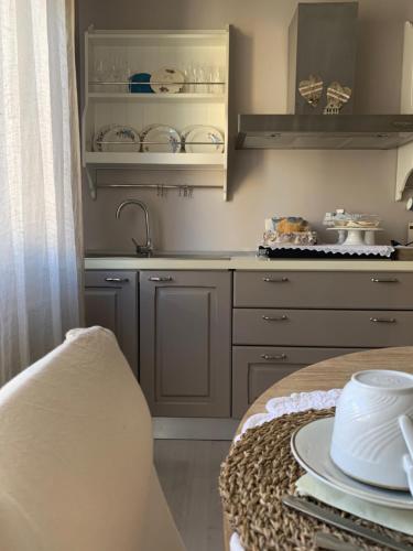 a kitchen with a sink and a counter with dishes at Appartamento Biancospino in Abbadia San Salvatore