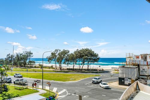 a view of a street with cars parked on the beach at Rhapsody Resort - Official in Gold Coast