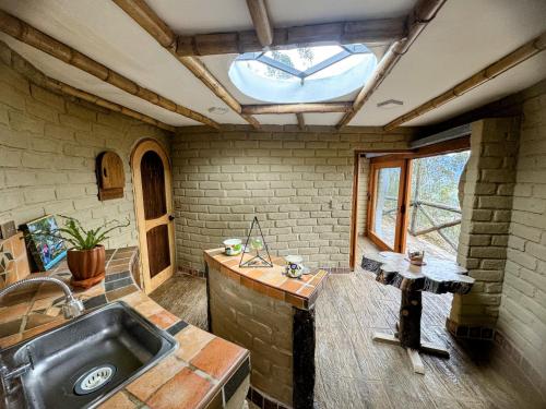 a kitchen with a sink and a window at De Los Angeles Glamping in Santa Sofía