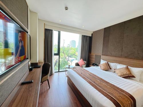 a hotel room with a large bed and a large window at Northern Charm Hotel in Ho Chi Minh City