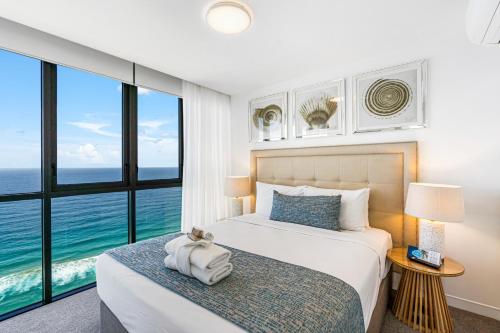 a bedroom with a bed with a view of the ocean at Rhapsody Resort - Official in Gold Coast
