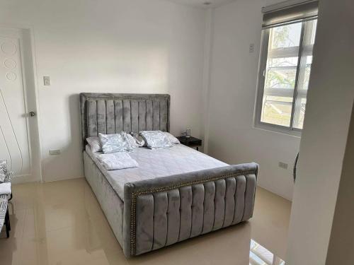 a bed in a bedroom with a metal bed frame at One Bedroom in CazaTara - Modern Villa with Pool in Alaminos