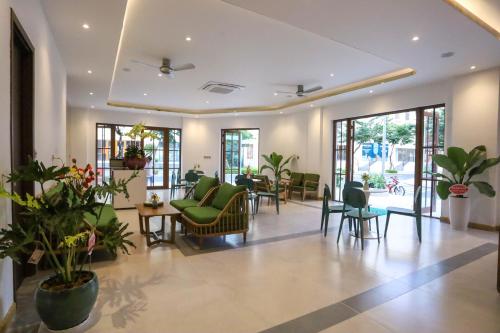 a lobby of a hospital with chairs and tables at Mimosa Hotel Phú Quốc in Phu Quoc