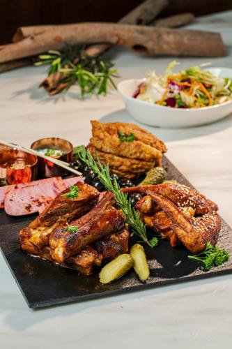a plate of food with meat and vegetables on a table at The Five Residences Hanoi in Hanoi