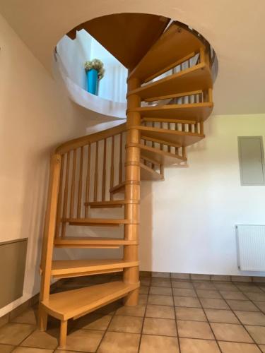 a wooden spiral staircase in a room with a window at Haus Allgäu Ruh in Görisried