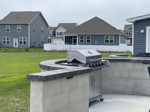 a grill sitting on top of a stone counter in a yard at Gorgeous Seaside Paradise - Ultimate Family Getaway! in Ocean View