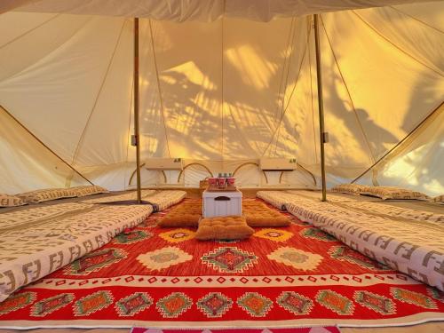 a tent with two beds and a table in it at TP-HOMES PHAN THIẾT in Phan Thiet