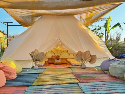 a large white tent with pillows on the floor at TP-HOMES PHAN THIẾT in Phan Thiet
