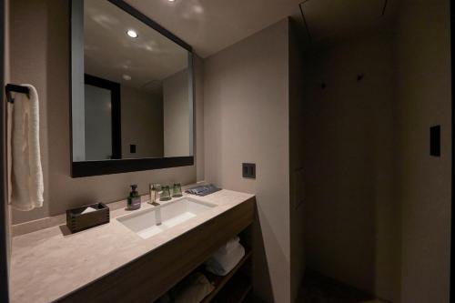 a bathroom with a sink and a mirror at NOHGA HOTEL KIYOMIZU KYOTO in Kyoto