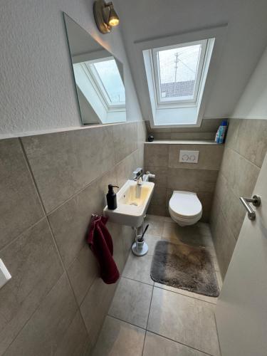 a bathroom with a sink and a toilet at Sonnenschein Chalet in Buxheim