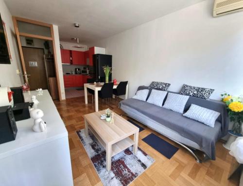 a living room with a couch and a table at AppLuna in Zagreb