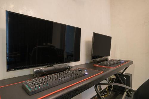 a desk with a computer monitor and a keyboard and mouse at Ignis Hotel busan sports complex branch in Busan
