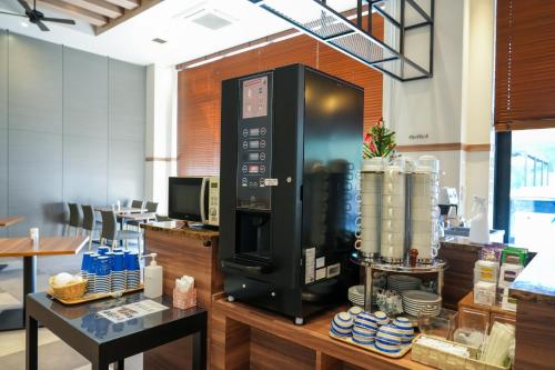 a coffee machine on a counter in a restaurant at Airport Hotel Kumamoto in Ozu