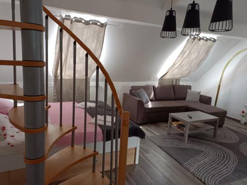 a living room with a staircase and a couch at Pension DonauBlick Grein 2 in Stifterstrasse 19A in Grein