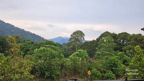 a view of a forest with mountains in the background at Ruzarani Home Meru Suria in Chemor