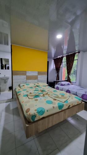 a bedroom with a large bed in a room at Hotel la garza roja in Villavicencio