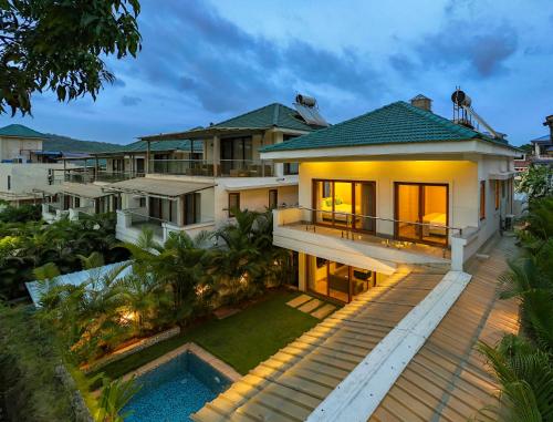 an aerial view of a house with a pool at ELIVAAS 3 BHK with Pvt Pool - Azalea in Siolim