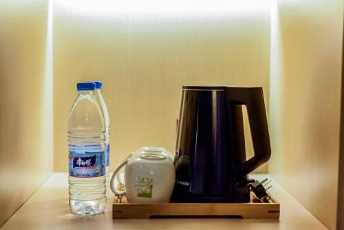 a bottle of water sitting next to a coffee maker at Heye Youth Hostel - Xian Bell Tower in Xi'an
