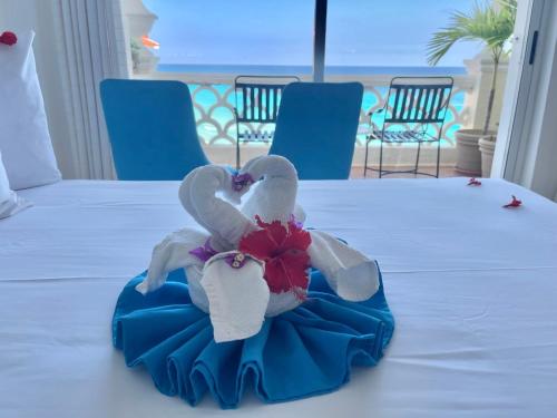 a stuffed bird sitting on top of a bed at OVA Apartments Cancun in Cancún