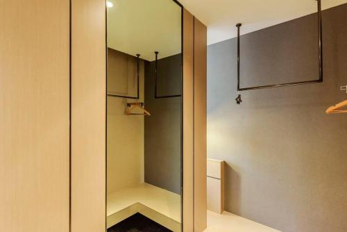 a walk in closet with a glass door at Heye Youth Hostel - Xian Bell Tower in Xi'an