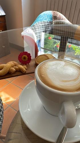 a cup of coffee sitting on a table at Hotel Miramonti in Campodolcino