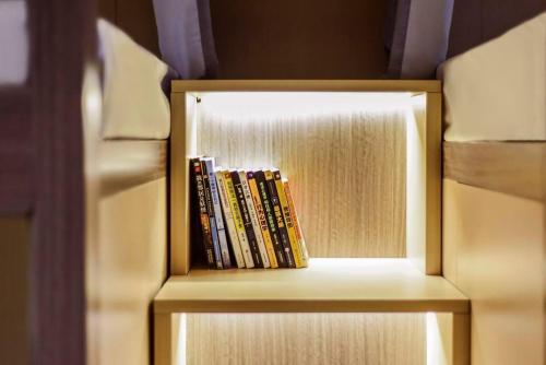 a book shelf filled with books in a refrigerator at Heye Youth Hostel - Xian Bell Tower in Xi'an