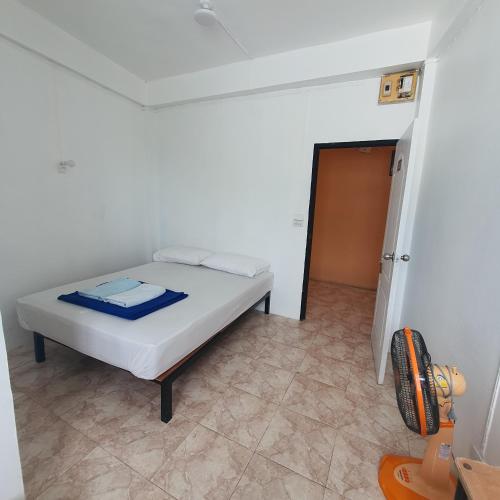 a bedroom with a bed in a white room at 8 homestel in Koh Tao