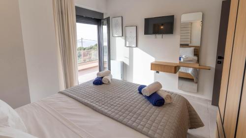 a bedroom with a bed with blue towels on it at Adaman Villas in Meganisi