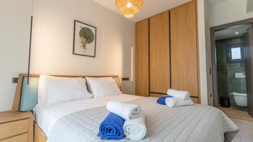 a bedroom with a bed with towels on it at Adaman Villas in Meganisi