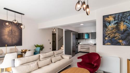 a living room with a white couch and a red chair at Adaman Villas in Meganisi