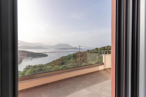 a balcony with a view of the water at Adaman Villas in Meganisi