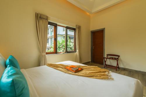 a bedroom with a bed with a blanket on it at ELIVAAS 3 BHK with Pvt Pool - Azalea in Siolim