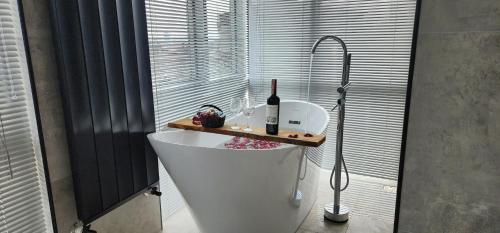 a bath tub with a bottle of wine on top of it at Dream house 22 in Istanbul