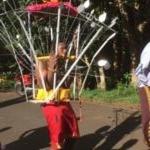 a man standing in front of a ferris wheel at Eden Villa in Belle Mare