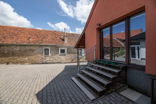 a building with a staircase next to a building with windows at Chalupa Dešná in Dešná