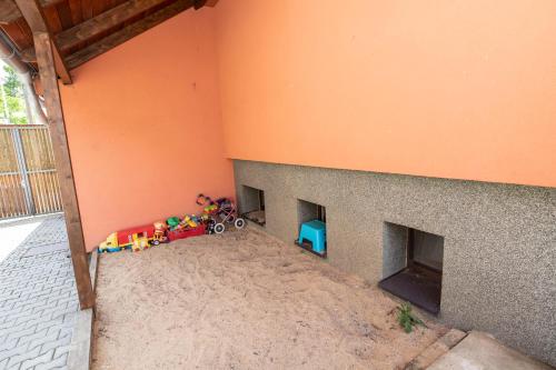 a corner of a room with a playroom with toys in it at Chalupa Dešná in Dešná