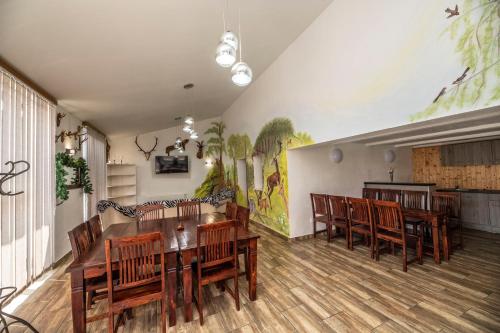 a dining room with a table and wooden chairs at Chalupa Dešná in Dešná