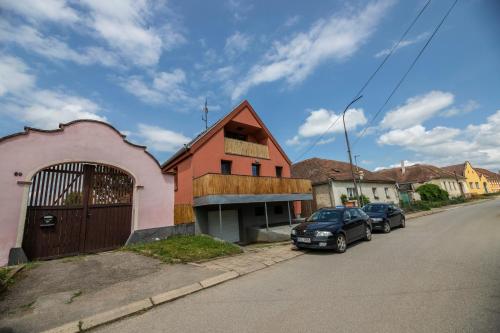 a house with a car parked on the side of a street at Chalupa Dešná in Dešná