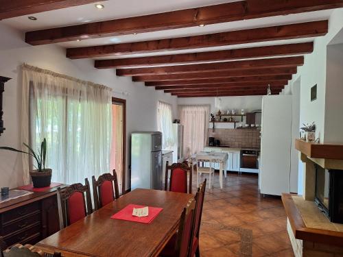 a dining room with a table and a kitchen at Villa Fiumana in Rijeka