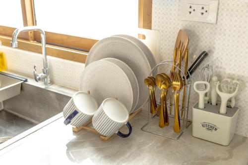 a kitchen counter with plates and utensils on it at Neverland in Ko Phangan