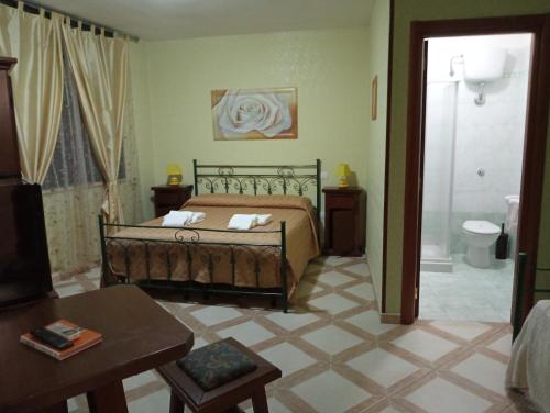 a bedroom with a bed and a bathroom at Mamma Assunta in Melendugno