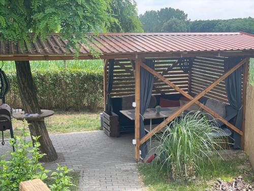 a wooden gazebo with a wooden roof at Sklípek-chatka Bella Moravia in Dobré Pole