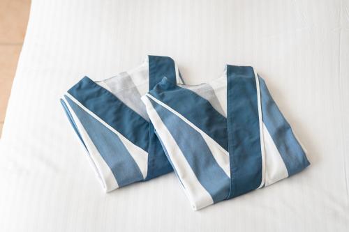 two blue and white ties hanging on a wall at EN RESORT Kumejima EEF Beach Hotel in Kumejima