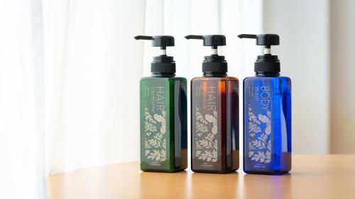 a group of three bottles sitting on a table at EN RESORT Kumejima EEF Beach Hotel in Kumejima