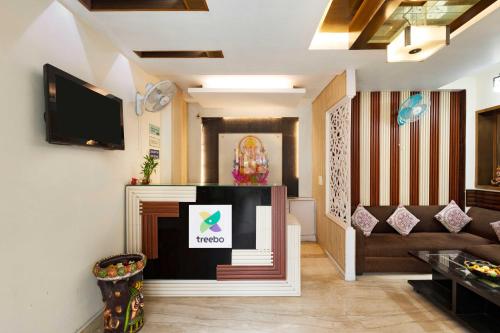 a living room with a tv and a couch at Treebo White Castle, Gurgaon in Gurgaon
